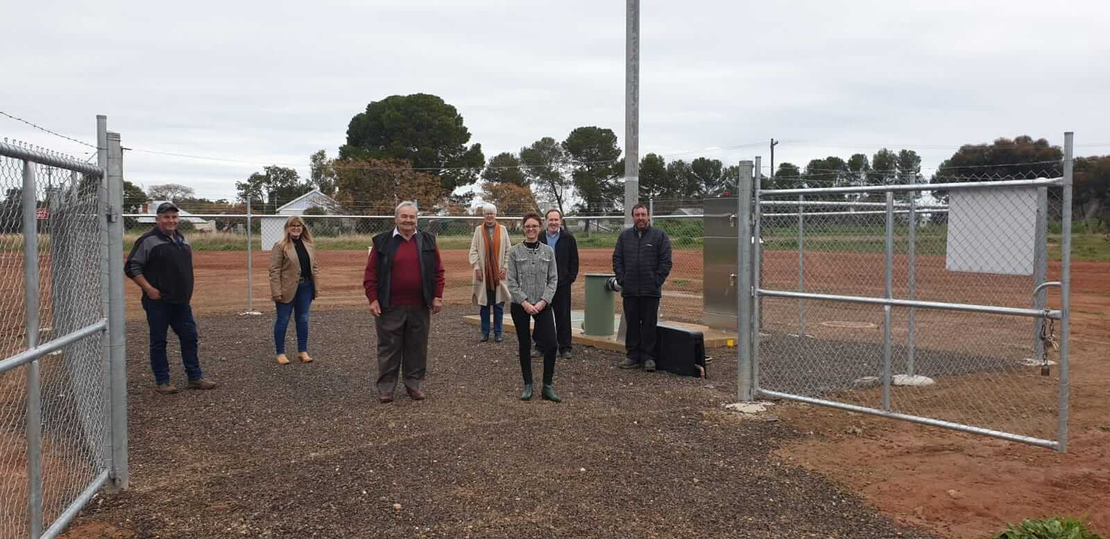 Steph Cooke MP and members of the Coolamon Shire Council stand in the gateway of the new Ardlethan Sewerage Treatment Plant.
