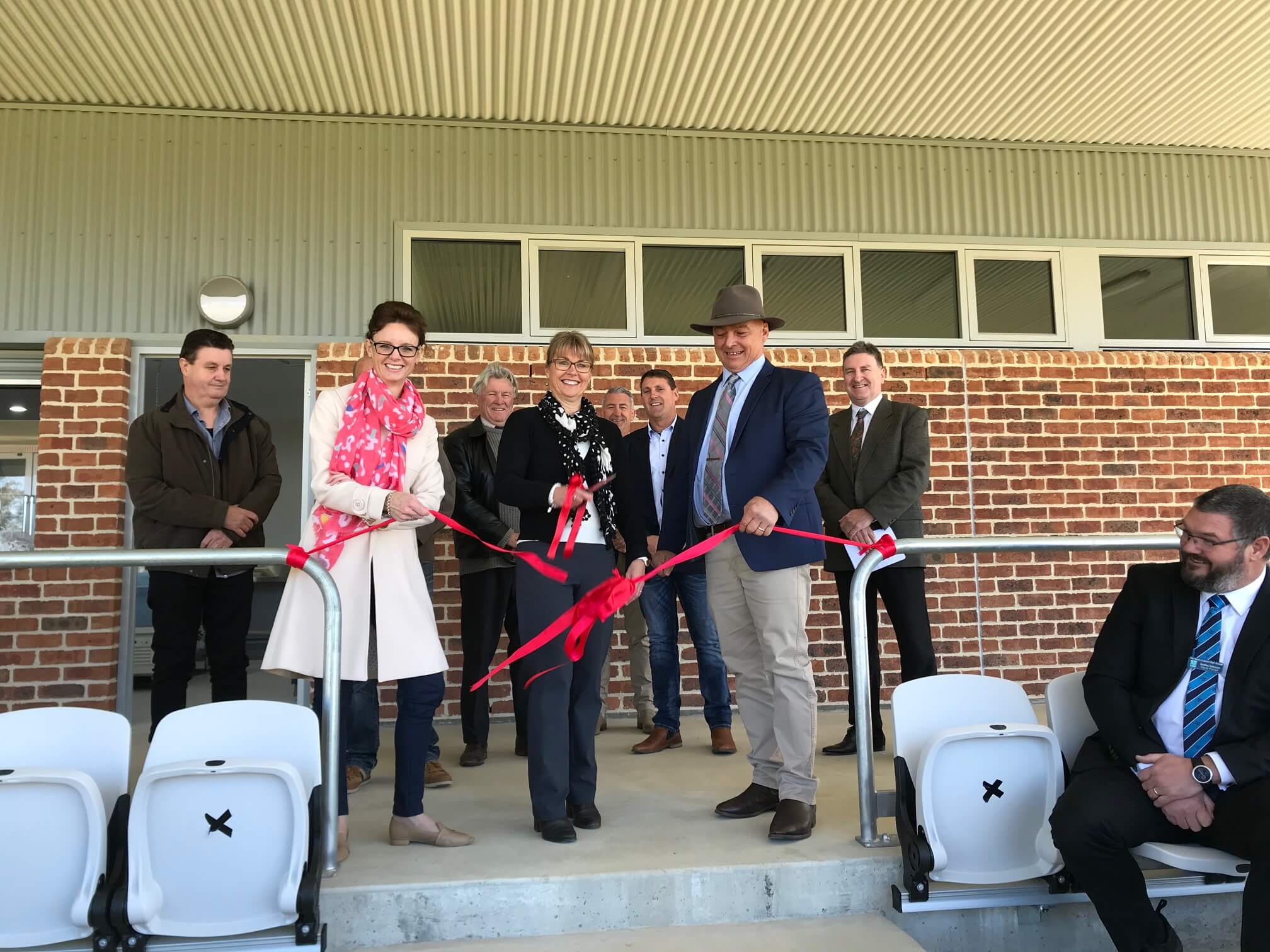 Steph Cooke, Mayor Mark Liebich and others cut a red ribbon to open the grandstand.