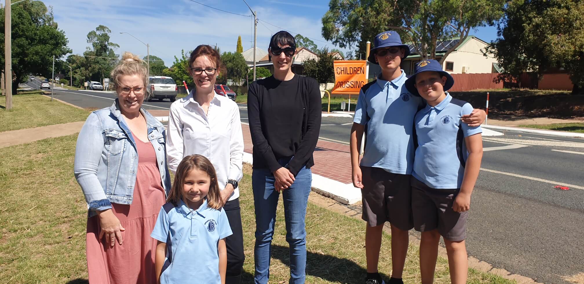 Renee Ford, Ana Djukic, Steph Cooke MP, Carrie Giddings, David and Marko Djukic stand in front of a school crossing.