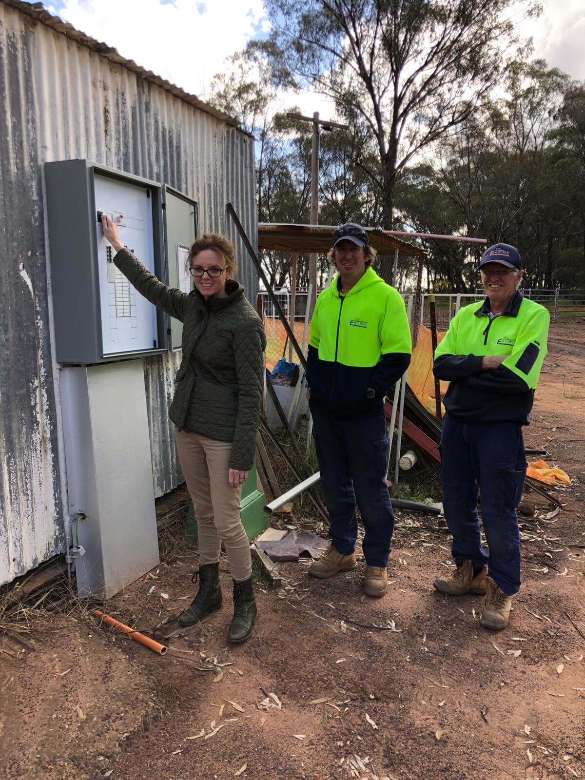 Steph Cooke MP with contractors Andrew and Garry Conlon at the rodeo ground. They stand in front of a new electrical box.