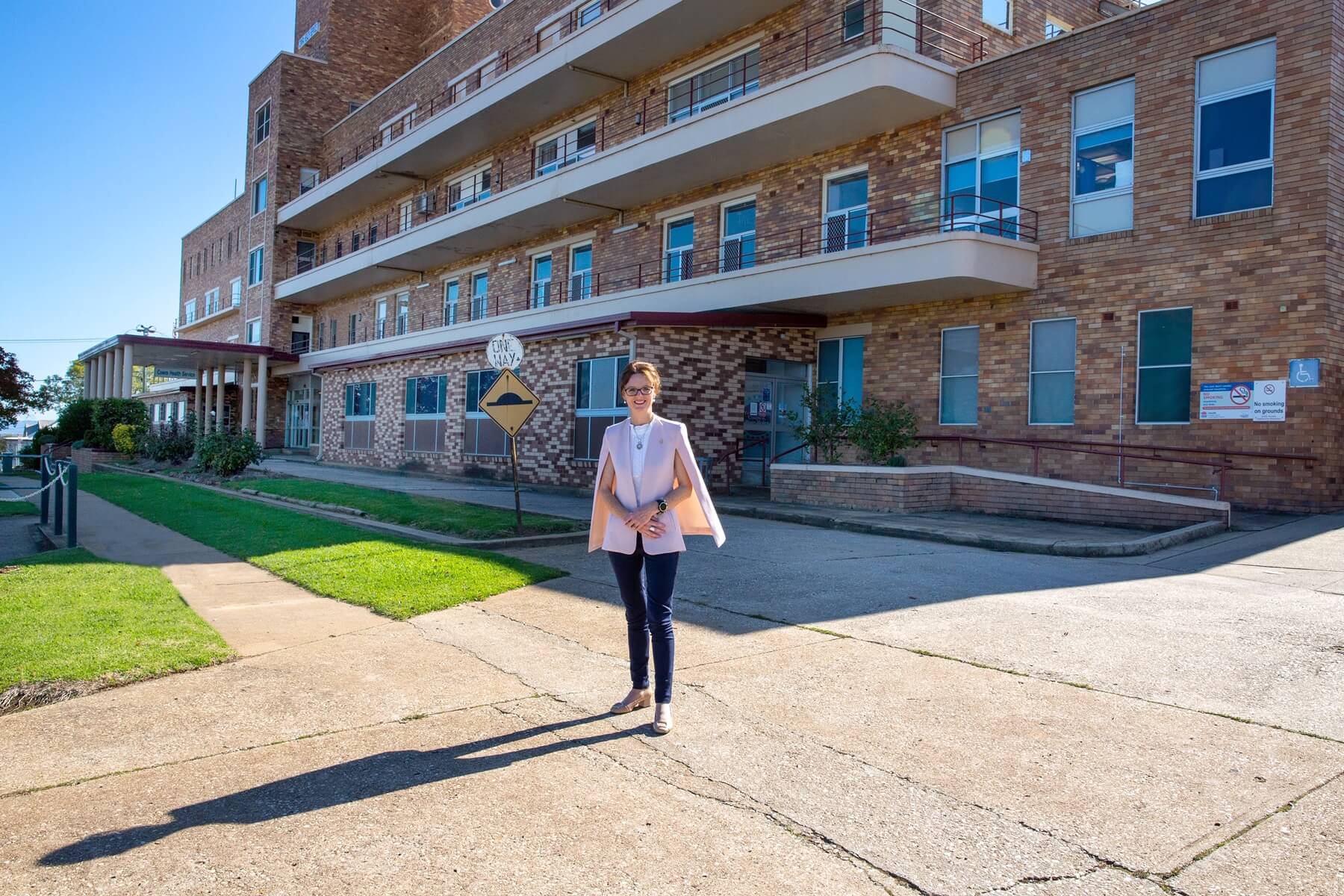 Steph Cooke stands in the sunshine out out the front of the Cowra Hospital.